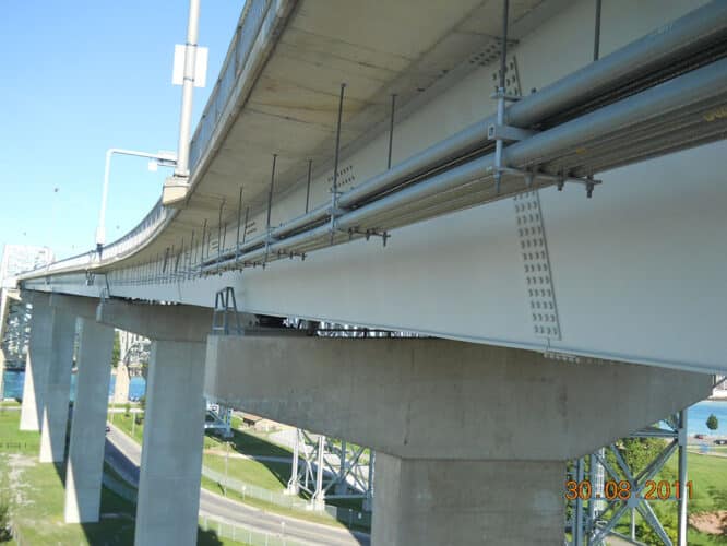 Champion Duct® RTRC fiberglass conduit on above-ground supports at UL Listed extended support spacing distances.
