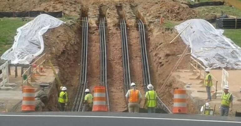 electrical conduit being buried underground