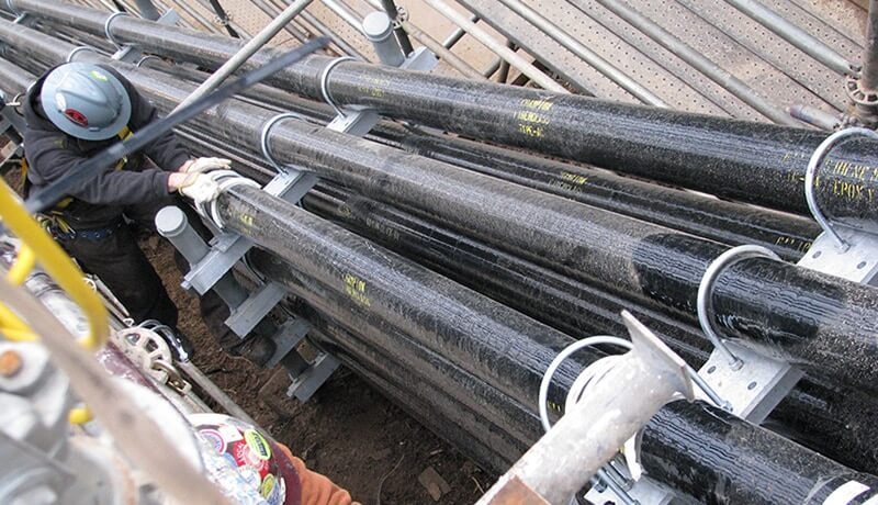 Photo of worker installing fiberglass conduit