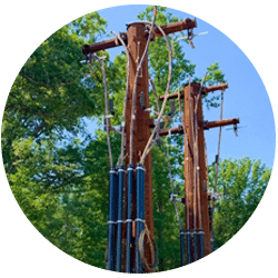 Champion fiberglass pole risers installed on wooden utility poles carrying cable from underground to overhead