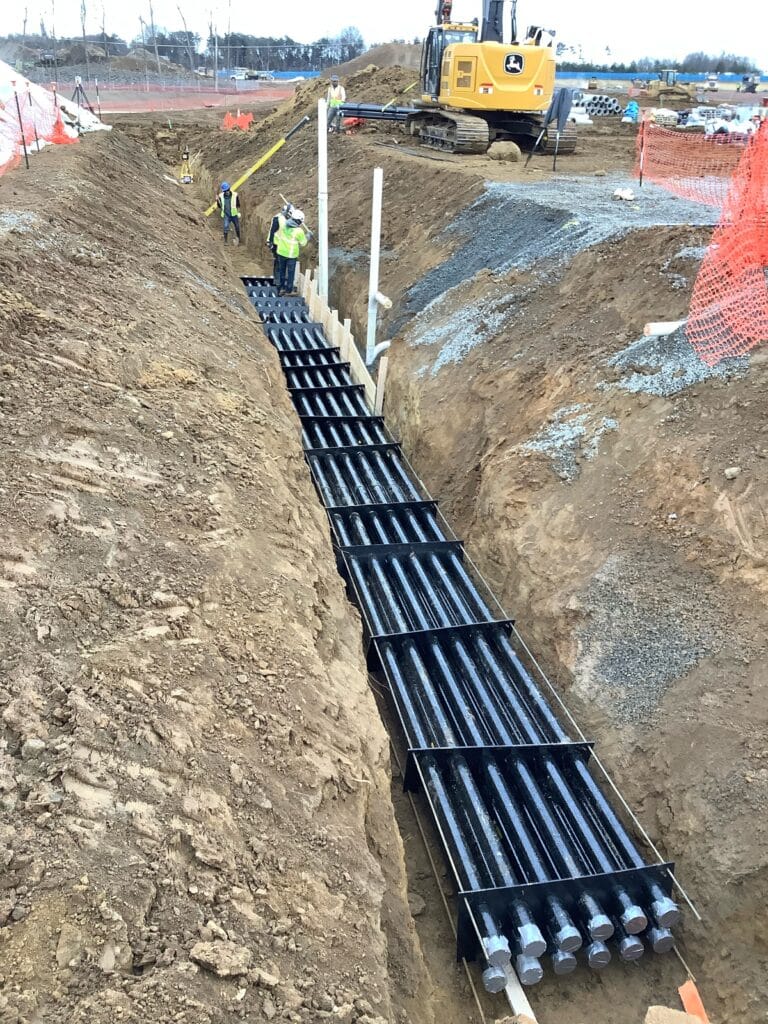 Fiberglass conduit duct banks in a trench.
