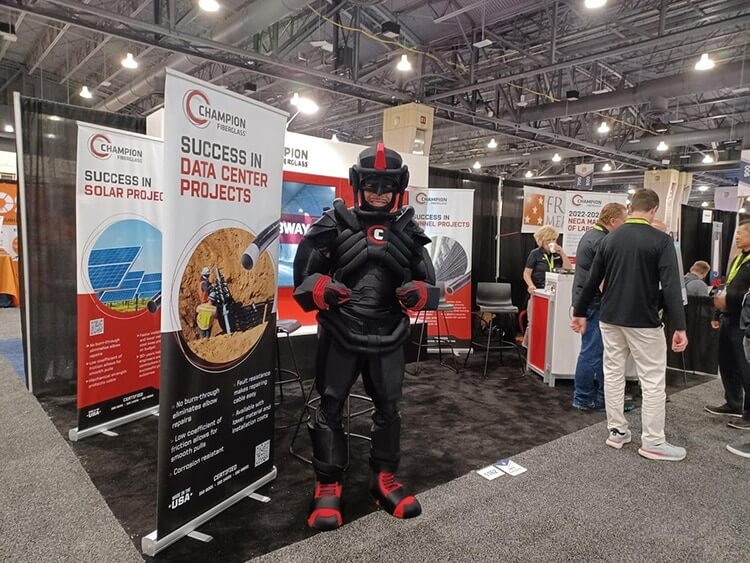 Black armored robot mascot standing at industry trade